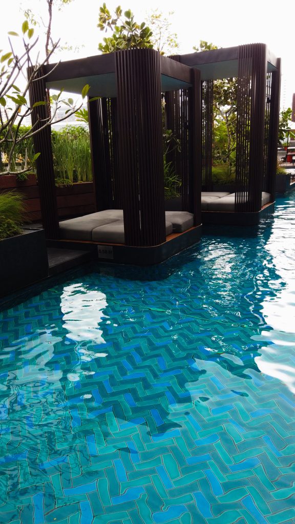 Rooftop pool with lush greenery at Parkroyal Collection Kuala Lumpur