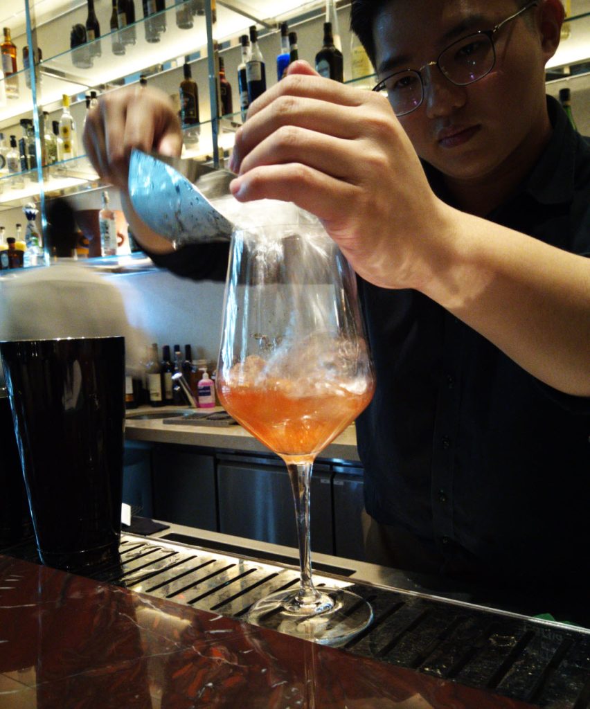 Bartender at Bottega di Carna mixing the Gin E Tonico