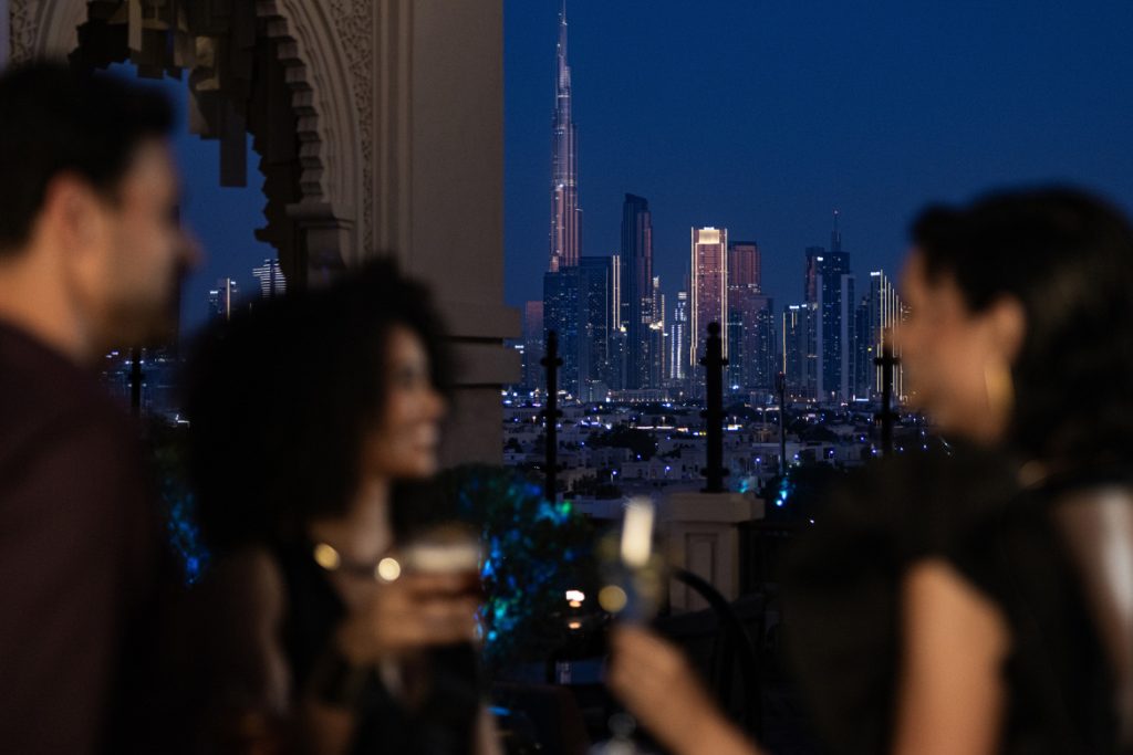 Four Seasons Jumeirah dinner guests overlooking Dubai skyline