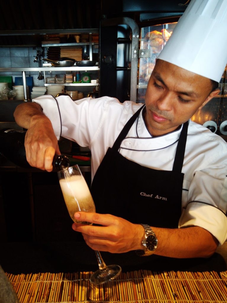 Catch Beach Club breakfast chef pouring prosecco