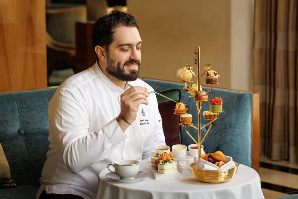 Executive Chef Rami Nasser tastes his new EARTH Afternoon Tea
